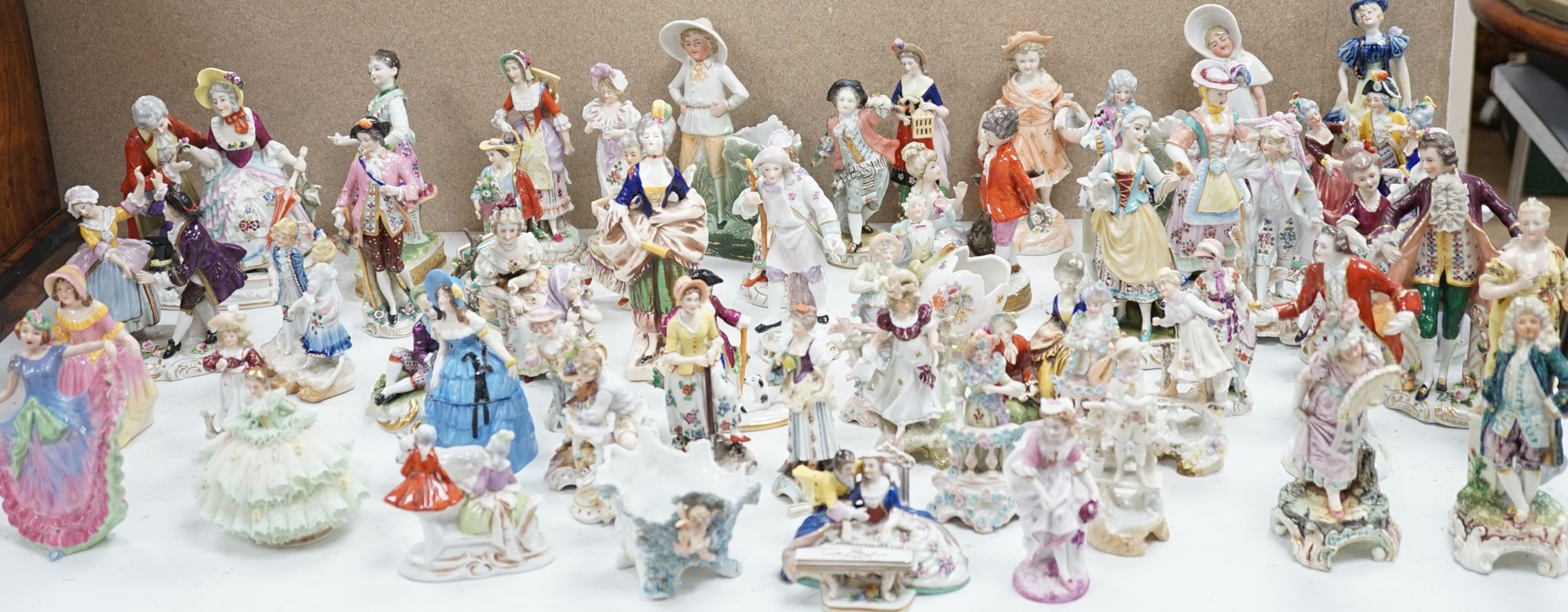 A large collection of small to medium German, French and English porcelain figurines and groups, tallest 18cm